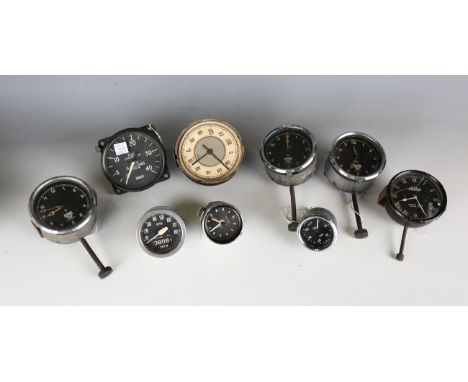 A Jaeger 8 day automobile dashboard clock and a small collection of mainly Smiths dashboard clocks and fuel and oil gauges.Bu