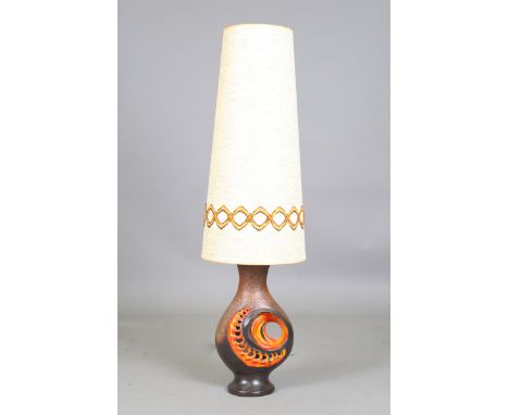 A 1970s style pottery table lamp, possibly West German, with a large conical shade, overall height 128cm.Buyer’s Premium 29.4