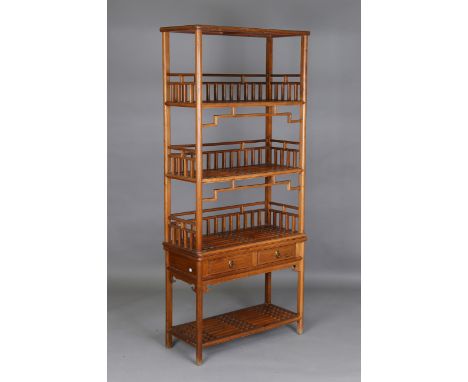 A Chinese softwood display shelf, the slatted open shelves above two drawers and an undertier, height 180cm, width 79cm, dept