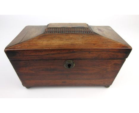 A Regency sarcophagus shaped rosewood tea caddy with two internal tea compartments on brass ball feet, h. 14 cm, w. 23 cm, d.