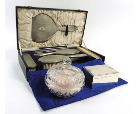 A cased silver mounted and engine turned six piece dressing table set comprising four brushes, a comb and a hand mirror, toge