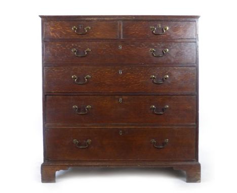 A late 18th century oak chest of two over four long graduated drawers with original gilt brass swan neck handles on bracket f