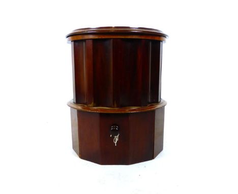 A Victorian mahogany circular commode with tooled leather insert to lift up top over accentuated fluted sides above pull out 