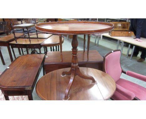 A late 18th century mahogany oval tilt top tripod table, the galleried, box wood line inlaid and crossbanded top on a turned 