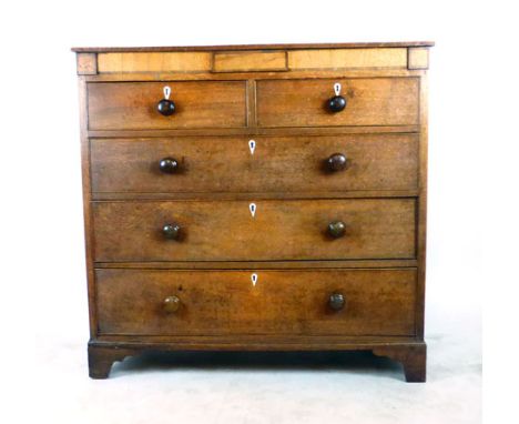 A George III oak chest of two short over three long drawers on shaped bracket feet. h. 111 cm, w. 115 cm, d. 52 cm   CONDITIO