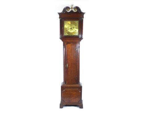 An 18th century oak longcase clock the swan neck pediment with eagle finial over the brass face with Roman and Arabic numeral