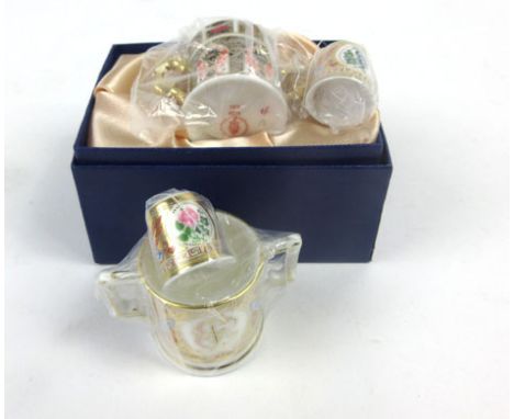 A cased pair of Royal Crown Derby thimbles by Hugh Gibson, together with two cased miniature loving cups