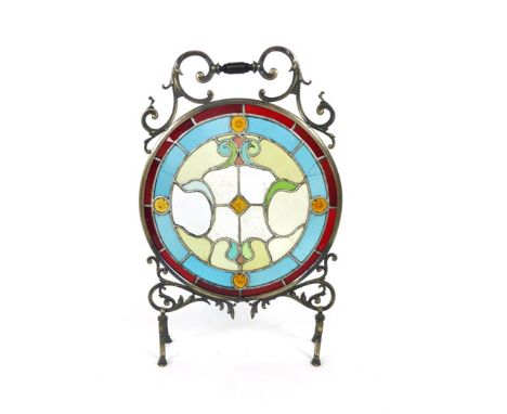A cast metal and leaded light circular fire screen, with scrolling brackets and turned ebonised handle. h. 75 cm, w. 50 cm   