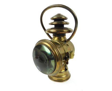 A French G. Ducellier Paris brass cased lantern headlamp, with red circular glass to back and marked to base 818 h. 39cm 