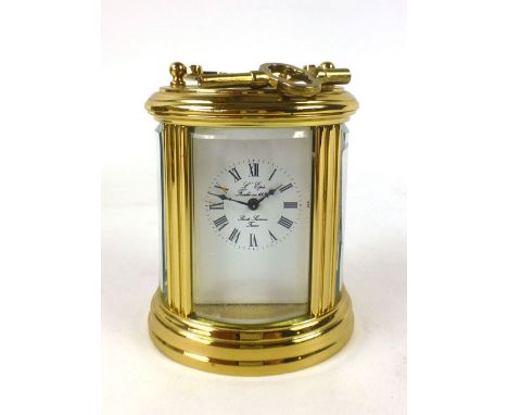 A French brass cased five glass oval carriage clock, the enamelled face with Roman numerals signed Saint Suzanne France. h. 1