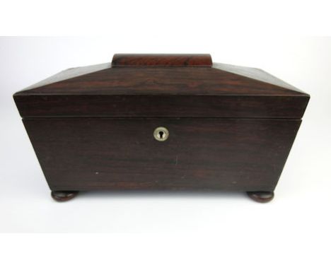 A regency sarcophagus shaped rosewood tea caddy with vacant interior on squat bun feet, h. 18 cm, w. 36 cm, d. 16 cm   CONDIT