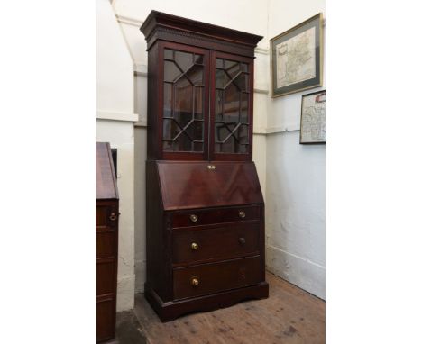 A late 19th century mahogany bureau bookcase with dentil pediment above two astragal glazed doors, the bureau lower section w