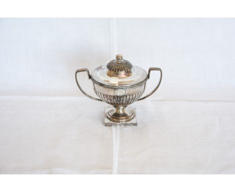 A Sheffield plate twin handled sucrier with gadrooned domed cover, beaded rim and angular handles above a gadrooned lower sec