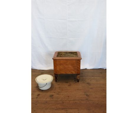 An Edwardian commode with carpet top, hinged lid opening to reveal a porcelain liner and cover, on turned legs.  17¼ins wide 