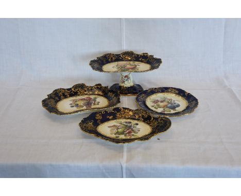 A Hammersley & Co fruit set, the central fields decorated with depictions of fruit surrounded by blue and gilt scroll decorat