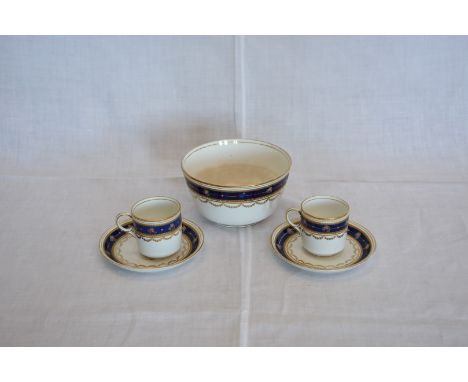 A late 19th century porcelain coffee set decorated with stylised flower heads on a blue and gilt ground comprising six coffee