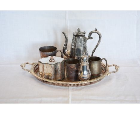 A plated coffee pot, a ditto sugar shaker, two plated tankards, a plate on copper tea caddy and a plated oval tray with pierc