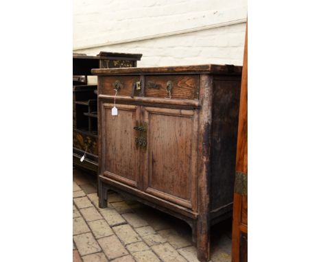 A 19th century elm Chinese cupboard with two frieze drawers above two panelled cupboard doors on bracket feet.  39¾ins wide. 