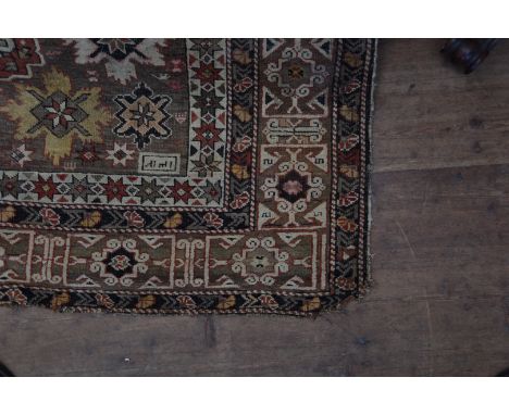 A Middle Eastern carpet with lozenge pattern centre surrounded by stylised flowers and multiple borders.  51 by 80ins (af).  