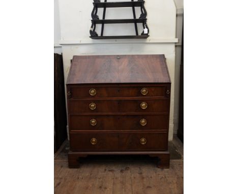 A Georgian mahogany bureau, the fall-flap opening to reveal a pigeonholed interior with arrangement of nine drawers above fou
