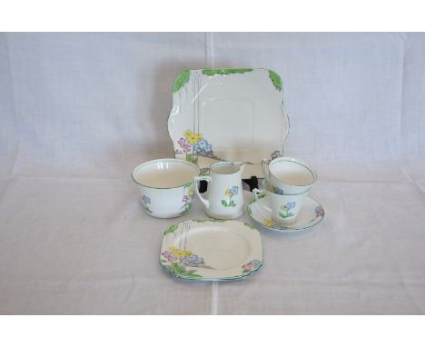 A Heathcote china, The Lea pattern tea set decorated with stylised flowers in a landscape comprising five teacups, six saucer