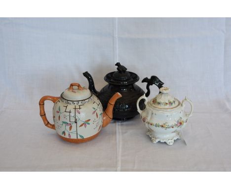 An oriental inspired teapot with bamboo effect spout and handle, the body decorated with stylised flowers and stamped to base