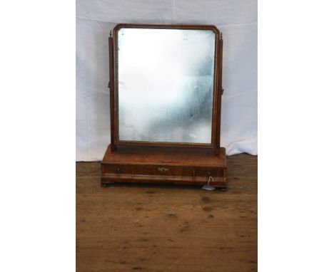 A George II walnut dressing table mirror with gilt slip to the mirror plate, square tapering uprights, the down-swept base wi