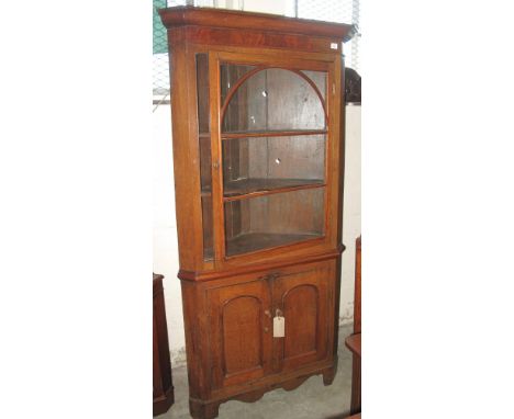 Early 19th Century oak corner cabinet with turned knob handles, on shaped apron and bracket feet.(B.P. 24% incl. VAT)