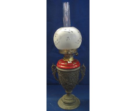 Early 20th Century oil lamp with ceramic reservoir and metal, urn shaped, two handled pedestal base, etched glass shade and c