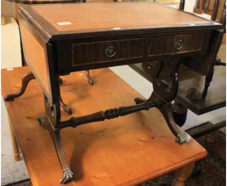 Small reproduction mahogany sofa table with inset leather surface and lyre supports on brass casters.(B.P. 24% incl. VAT)