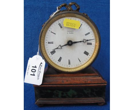 Small 19th Century drum head mantel clock with yellow metal ribboned pediment, white enamel face with Roman numerals marked: 