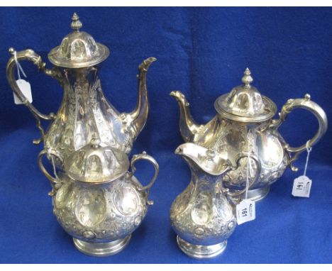 19th Century Continental white metal baluster shaped tea and coffee set, overall with repousse foliate decoration: teapot; su