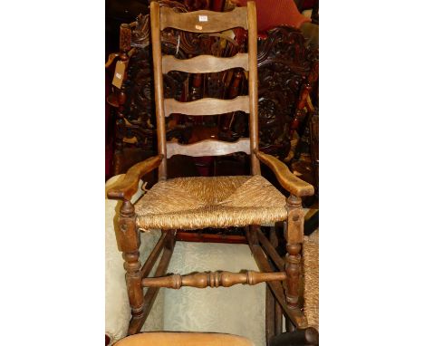 A 19th century elm and fruitwood rush seat ladder back rocking armchair, together with a further cane inset rocking armchair,