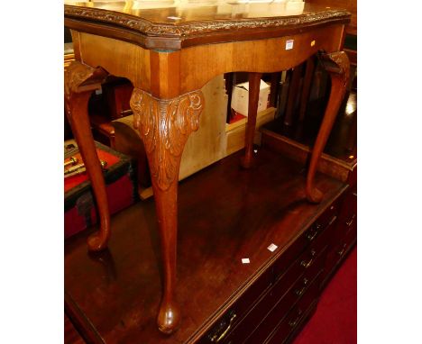 A 1930s figured walnut serpentine front fold-over baize lined card table, with swivel action, acanthus leaf detail, and on ca