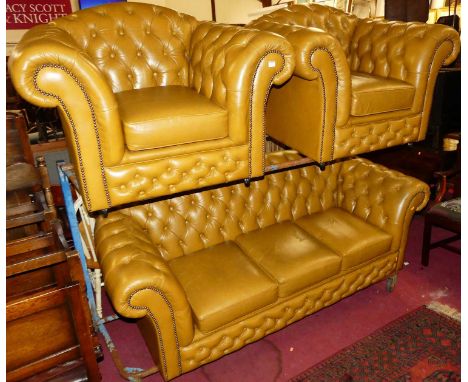 A contemporary leather buttoned upholstered Chesterfield suite, comprising three-seater sofa, w.200cm, and a pair of matching