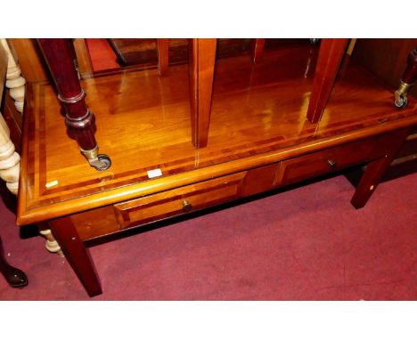 A contemporary cherrywood and crossbanded two-drawer rectangular low coffee table, width 120cm, together with a matching sing