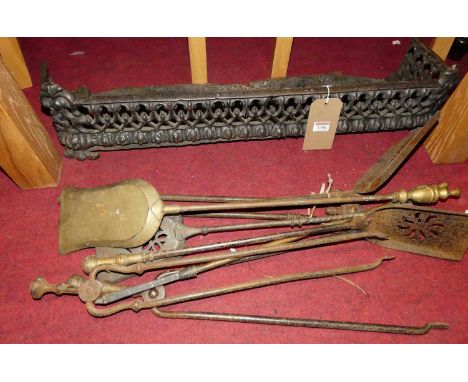 Sundry 19th century fire tools, and a pierced fender