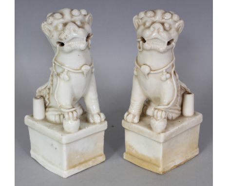 A PAIR OF 17TH/18TH CENTURY CHINESE KANGXI PERIOD DEHUA BLANC-DE-CHINE BUDDHISTIC LION JOSS STICK HOLDERS, each mythical anim