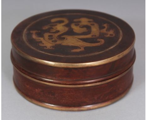 A CHINESE ARCHAIC STYLE GILT BRONZE CIRCULAR BOX & COVER, the cover decorated with a stylised dragon, the base cast with a se
