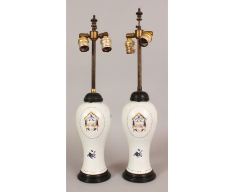 A PAIR OF CHINESE MONOGRAMMED PORCELAIN VASES, circa 1800, fitted for electricity, the sides of each baluster form body paint