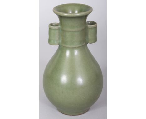 A CHINESE CELADON GLAZED PORCELAIN ARROW VASE, possibly early, the sides applied with an even glaze, 5.8in high.