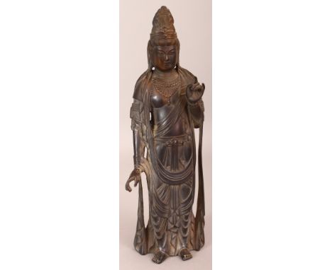 A CHINESE BRONZE FIGURE OF A STANDING GUANYIN, the bronze with small traces of gilding, 10.9in high.
