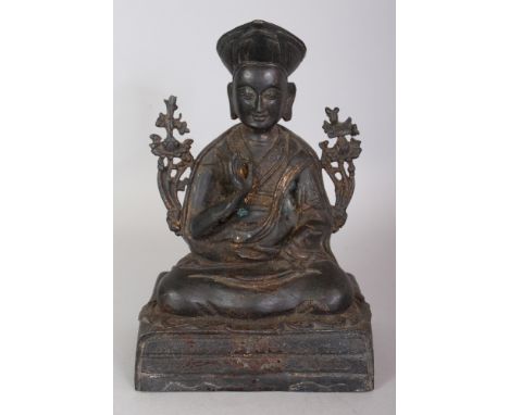 A CHINESE GILT BRONZE FIGURE OF A LAMA PRIEST, seated in dhyanasana on a rectangular plinth, the bronze with traces of gildin