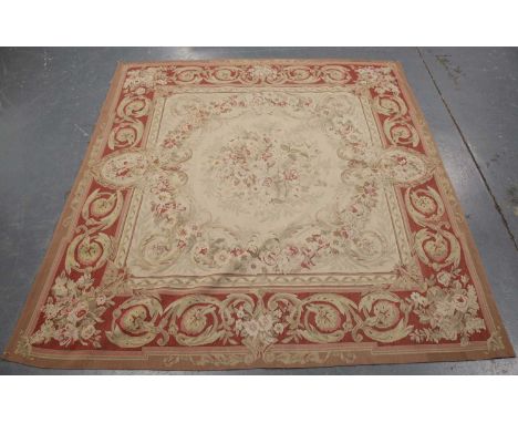 An Aubusson style carpet, late 20th century, the ivory field with a rose medallion, within a scrolling foliate border, 203cm 