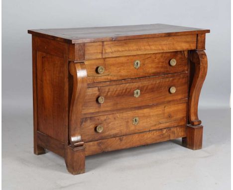 An early 19th century French walnut four-drawer commode with applied gilt brass handles, flanked by curved side pilasters, he