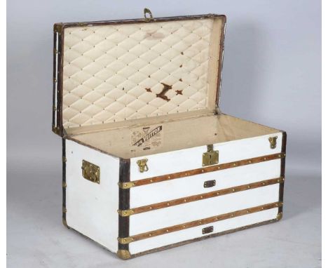 A late 19th/early 20th century Louis Vuitton trunk with overall leather mounted corners, wooden straps and brass mounts, the 