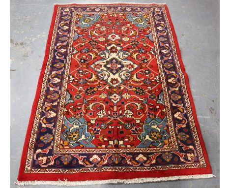 A Mahal rug, North-west Persia, late 20th century, the red field with a shaped medallion, within a midnight blue palmette bor