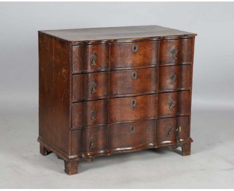 A mid-18th century Dutch oak four-drawer commode with a serpentine front, height 78cm, width 85cm, depth 49cm.