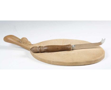 A Robert 'Mouseman' Thompson workshop oak cheese board, the handle with typical carved mouse signature, length 37cm, together