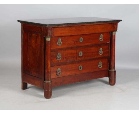 An early 19th century French mahogany four-drawer commode with a black marble top and turned columns, height 90cm, width 128c